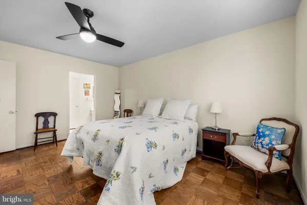 a spacious bedroom with a bed and a chair