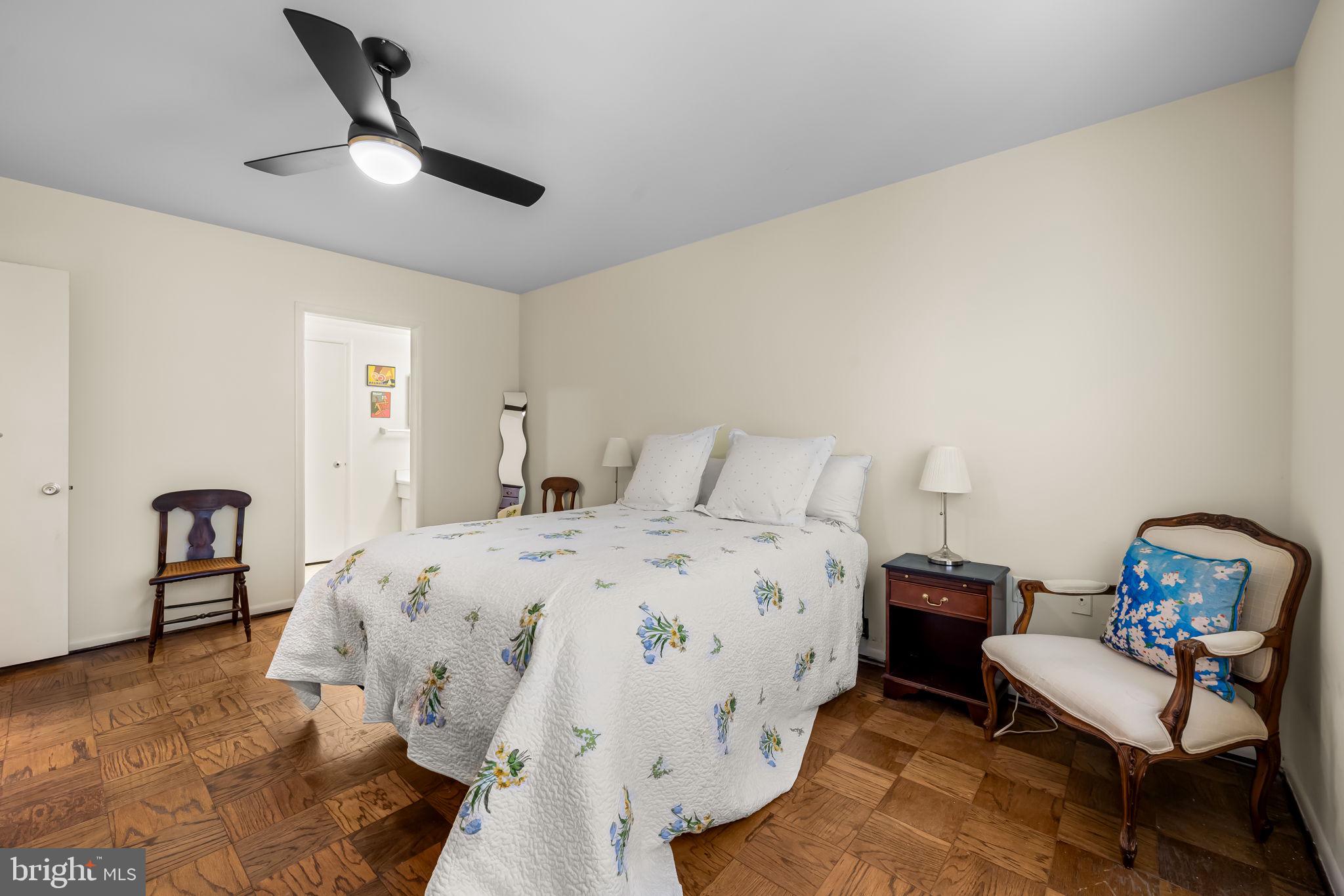 103 Cross Keys Road, Unit R103D2 Baltimore, MD 21210 - Photo 11 of 24 a spacious bedroom with a bed and a chair