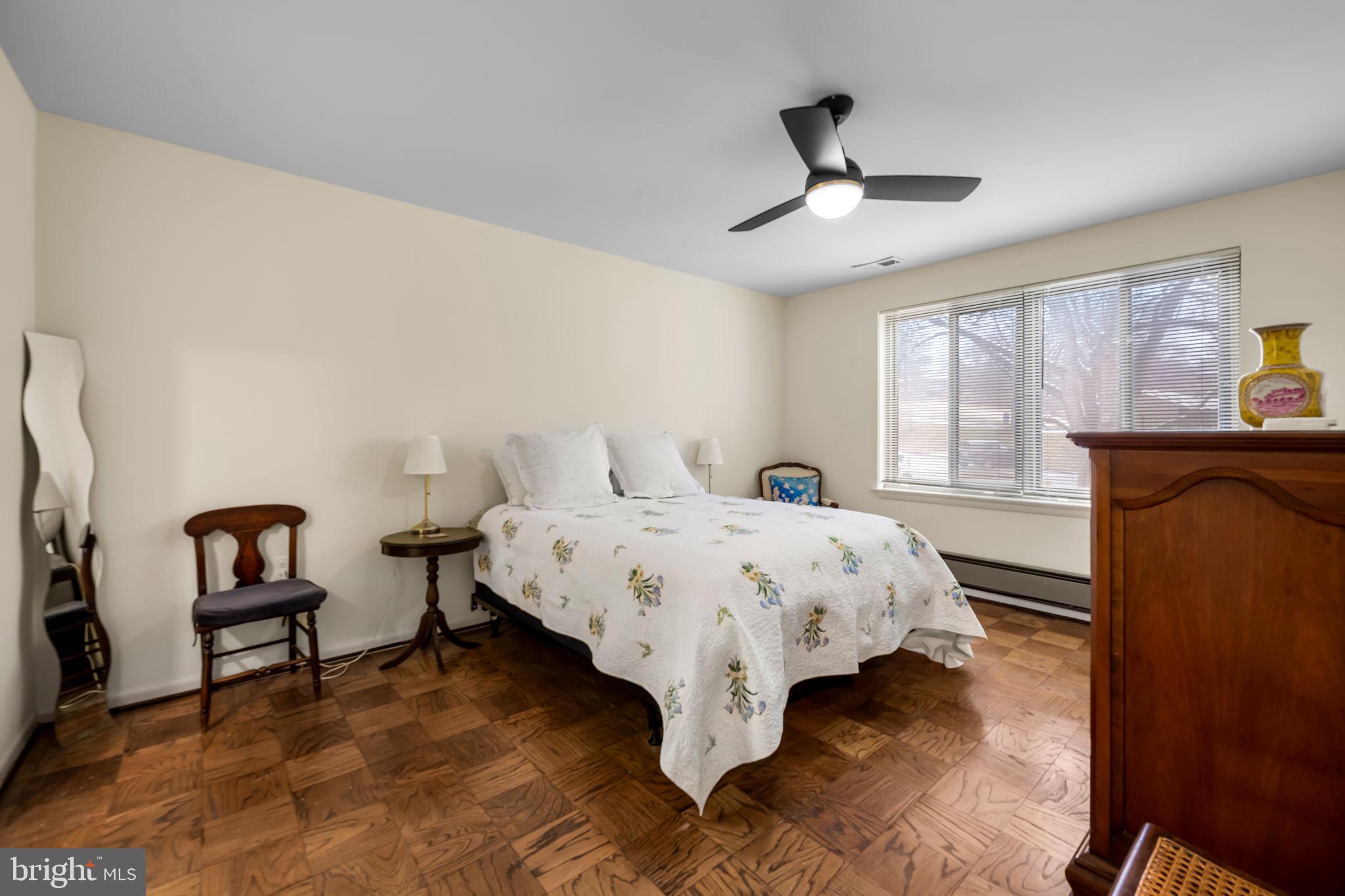 103 Cross Keys Road, Unit R103D2 Baltimore, MD 21210 - Photo 12 of 24 a bedroom with a bed and a chandelier