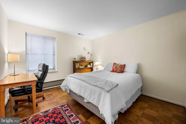 a bedroom with a bed a table and chair