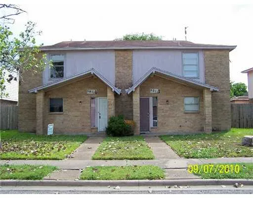 a front view of house with garage and green space