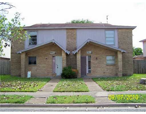 5011 Meandering Lane, Unit A Corpus Christi, TX 78413 - Photo 1 of 10 a front view of house with garage and green space