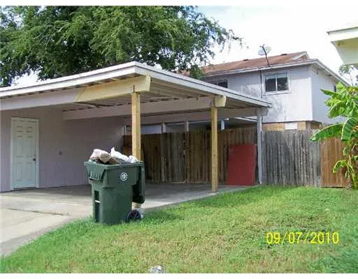a view of a chair with a house in the back yard