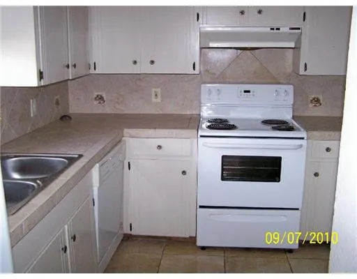 a kitchen with cabinets and appliances