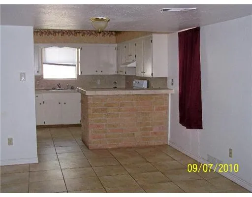 a view of kitchen with granite countertop cabinets