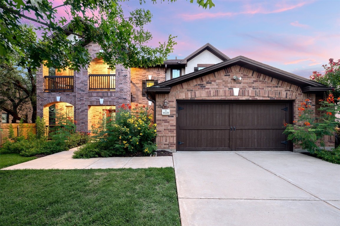 a view of backyard with potted plants and a large tree