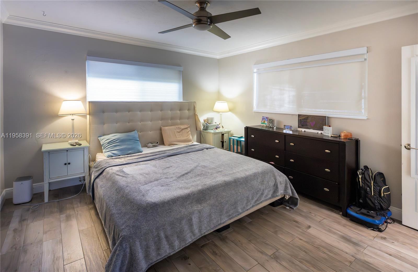 12415 Southwest 93rd Court Miami, FL 33176 - Photo 16 of 30 a bedroom with a bed and wooden floor