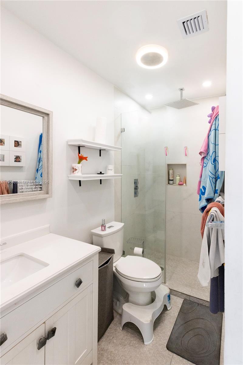 12415 Southwest 93rd Court Miami, FL 33176 - Photo 17 of 30 a bathroom with a sink a toilet and shower