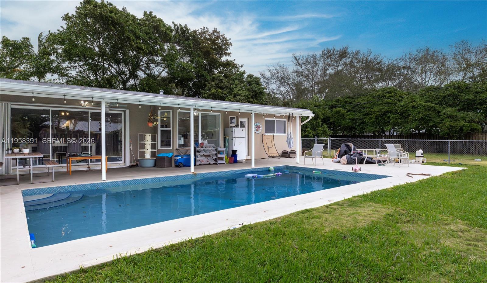 12415 Southwest 93rd Court Miami, FL 33176 - Photo 22 of 30 a view of a house with swimming pool and porch