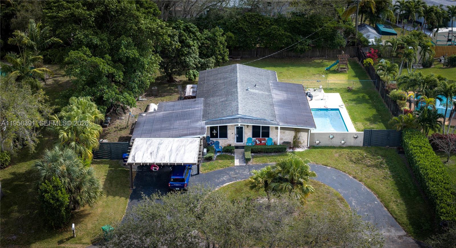 12415 Southwest 93rd Court Miami, FL 33176 - Photo 28 of 30 an aerial view of a house with swimming pool a yard and a fountain