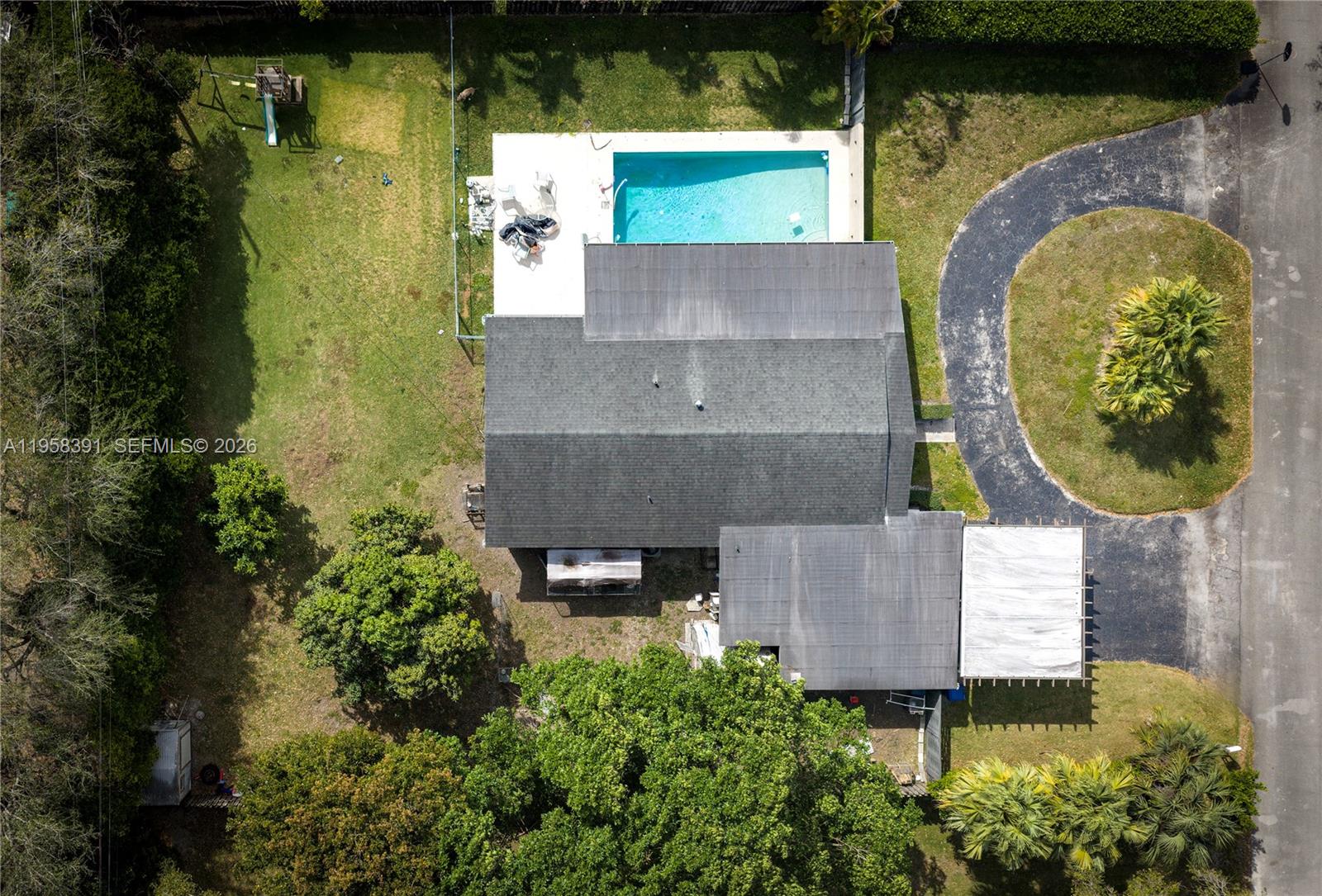 12415 Southwest 93rd Court Miami, FL 33176 - Photo 29 of 30 an aerial view of a house with swimming pool and large trees