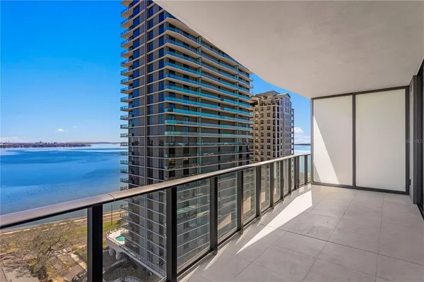 a kitchen with stainless steel appliances kitchen island a refrigerator sink and white cabinets
