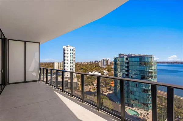 a kitchen with granite countertop white cabinets and stainless steel appliances