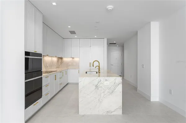 a living room with furniture a rug and a large window