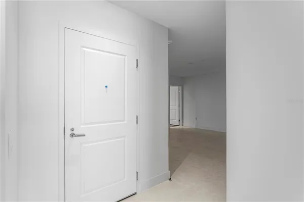 a large white kitchen with a large window