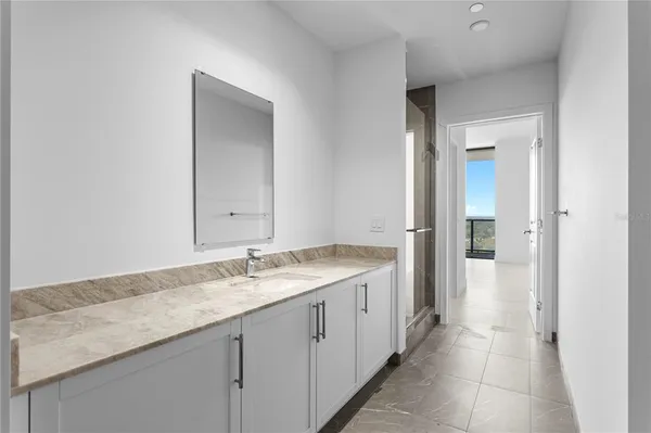 a living room with furniture a potted plant and a table