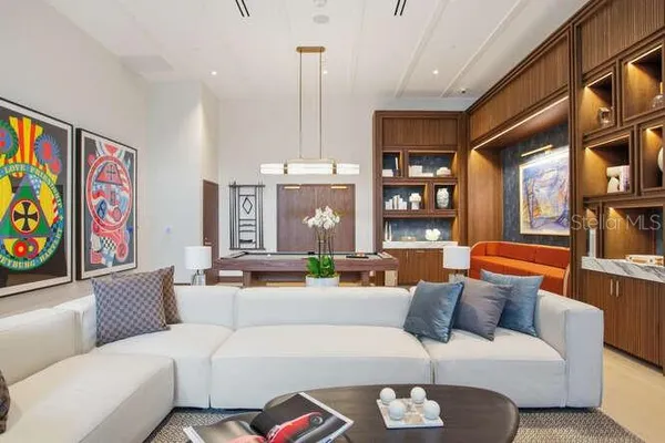 a living room with furniture a rug and a large window