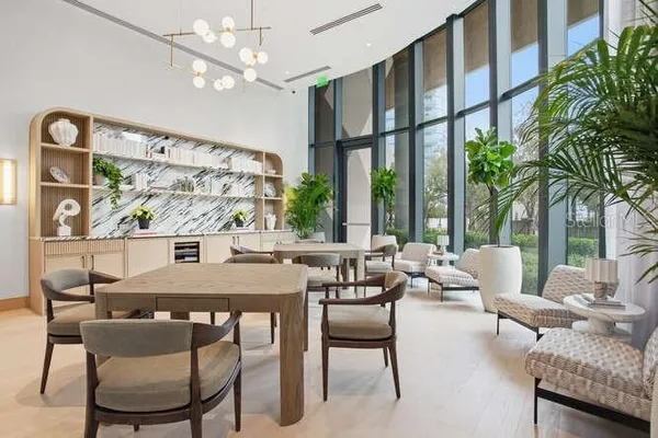a patio with patio a table and chairs and potted plants