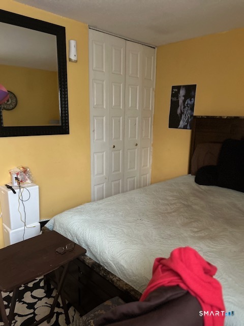 92 Angel Drive, Unit C Waterbury, CT 06708 - Photo 17 of 18 a bedroom with a bed and teddy bear on bed