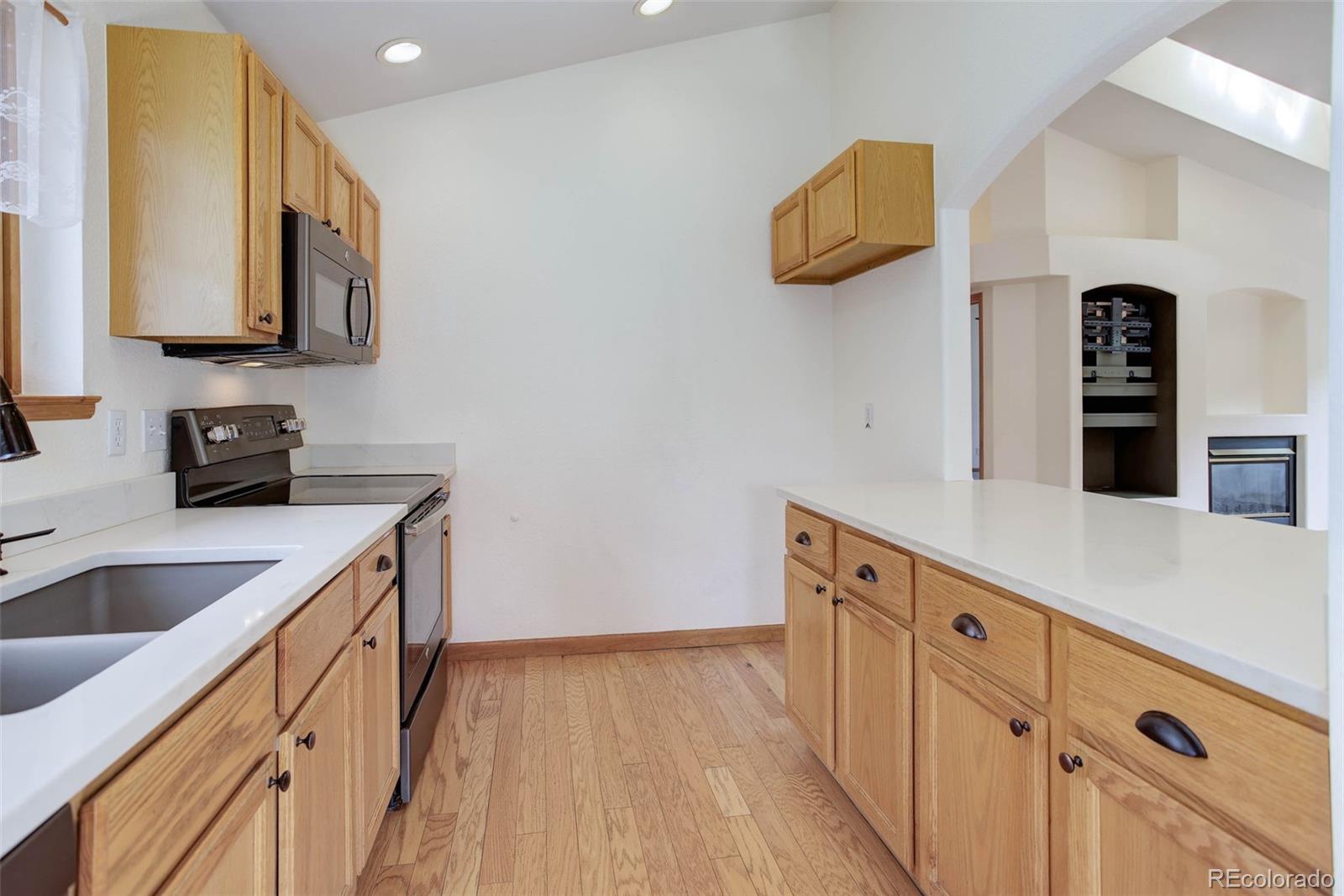 45 Catamount Ridge Road Bailey, CO 80421 - Photo 17 of 39 a kitchen with cabinets and wooden floor