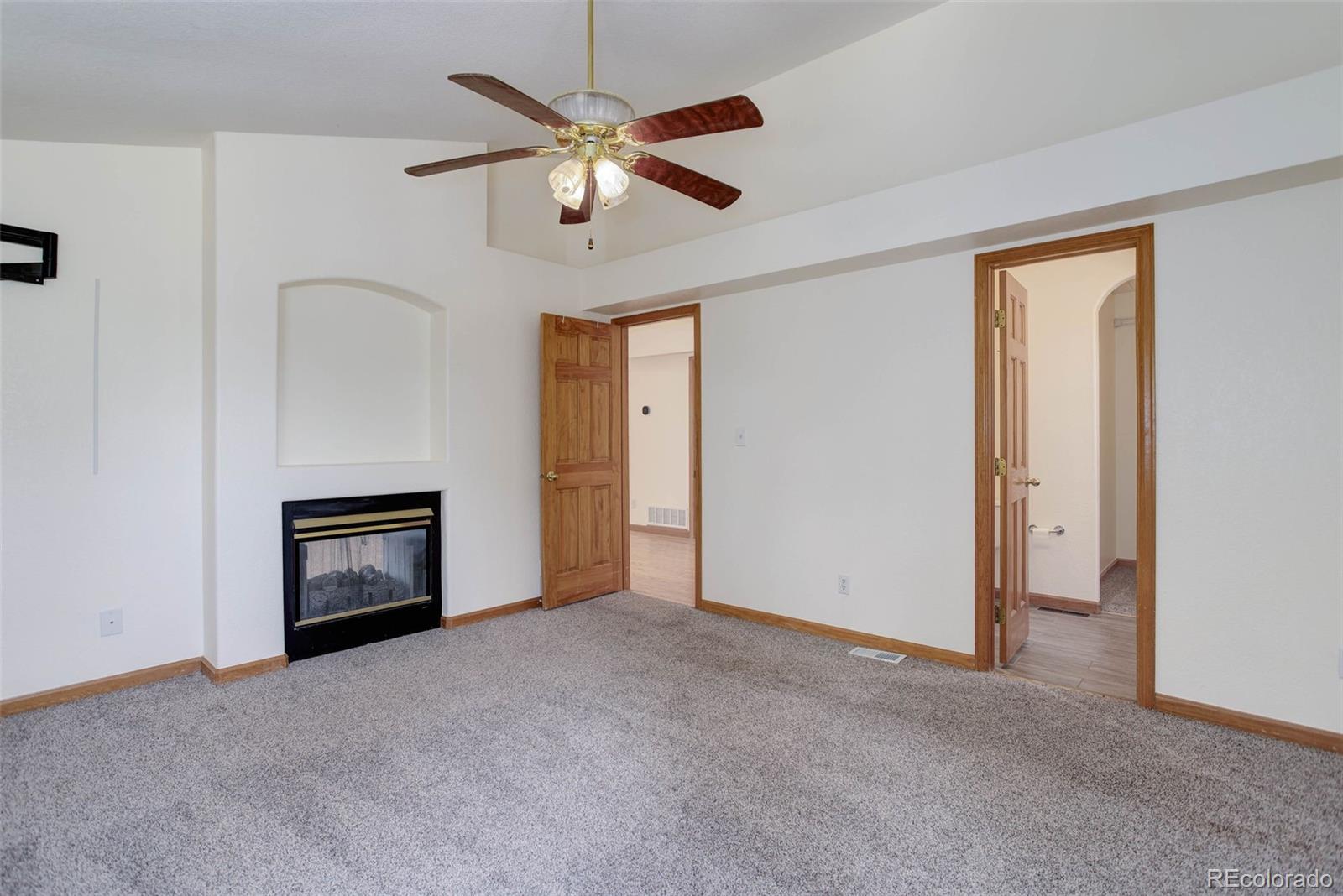 45 Catamount Ridge Road Bailey, CO 80421 - Photo 21 of 39 an empty room with chandelier fan and windows