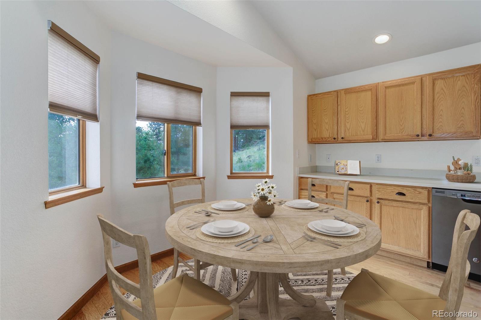45 Catamount Ridge Road Bailey, CO 80421 - Photo 5 of 39 a kitchen with a dining table chairs and window