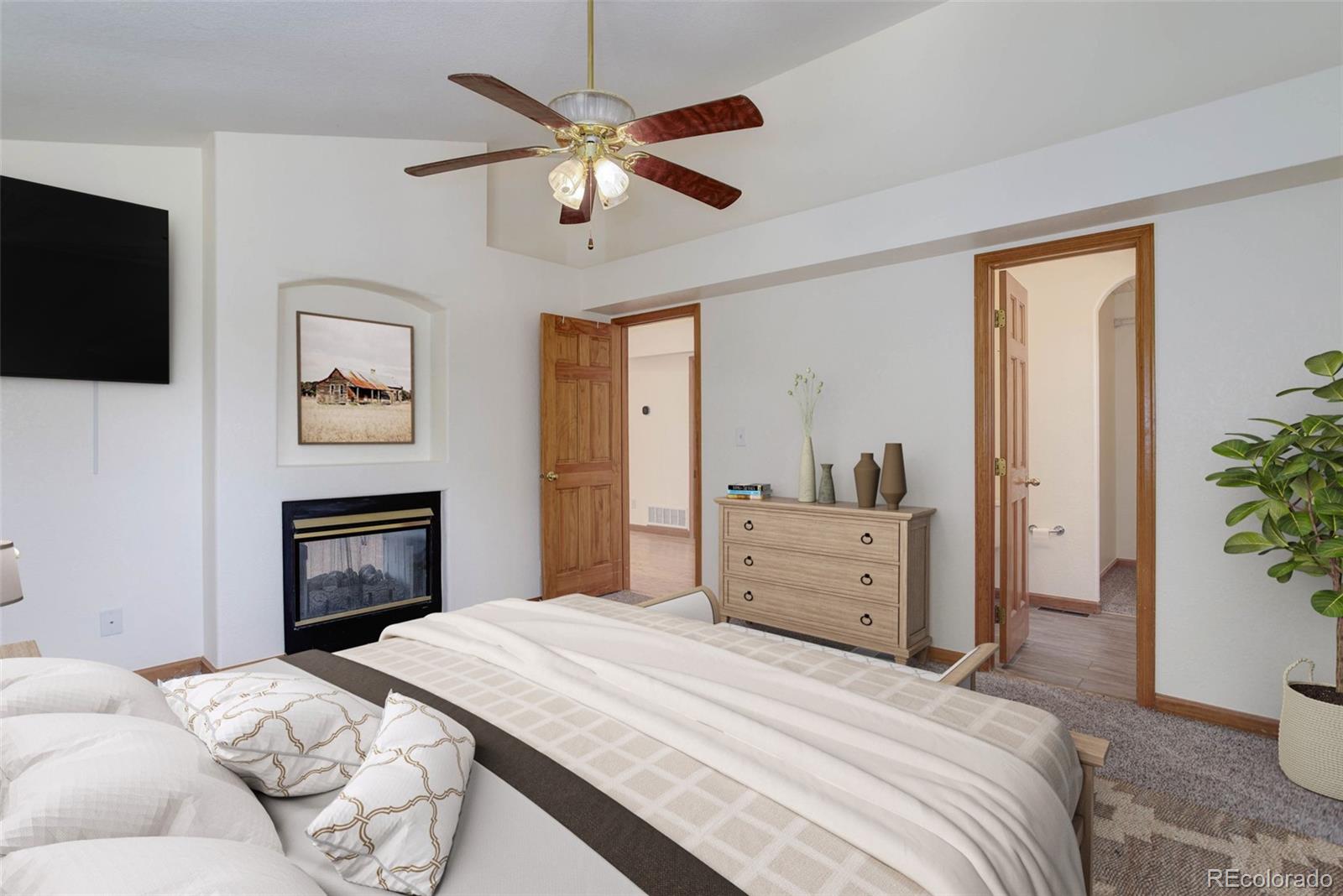 45 Catamount Ridge Road Bailey, CO 80421 - Photo 7 of 39 a bedroom with a bed and a fireplace