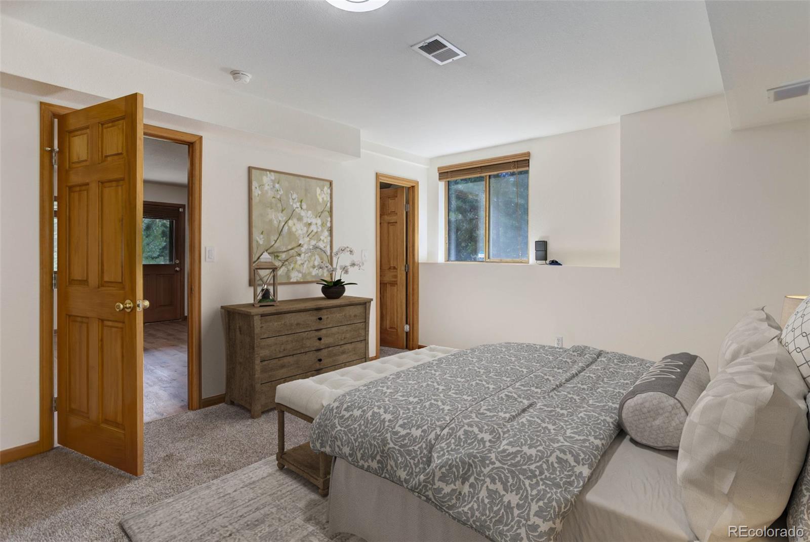 45 Catamount Ridge Road Bailey, CO 80421 - Photo 9 of 39 a bedroom with a bed and a dresser