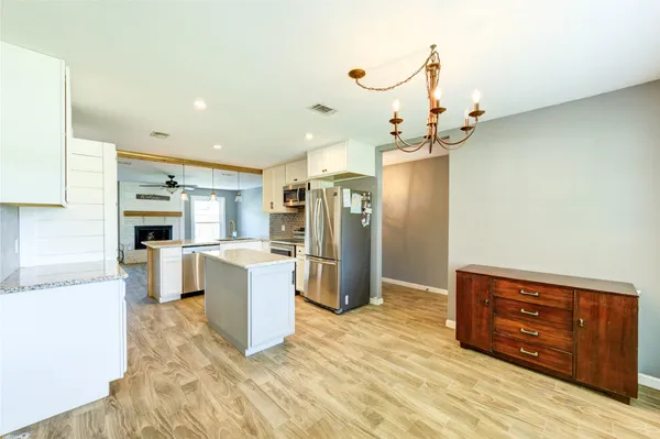 a kitchen with a refrigerator and a stove