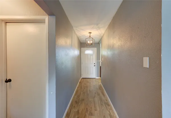 a view of a room with wooden floor