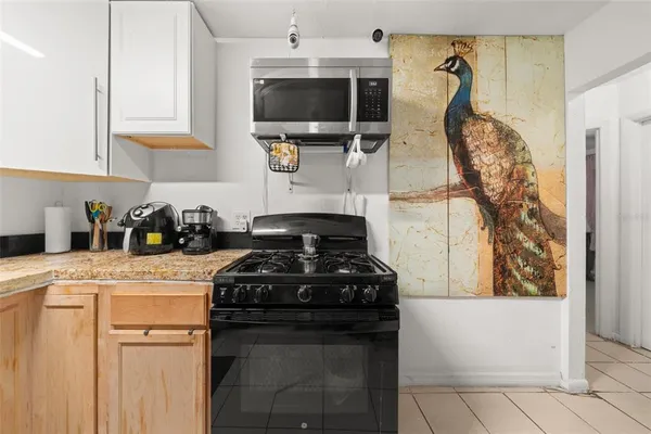 a kitchen with a stove and a white cabinet
