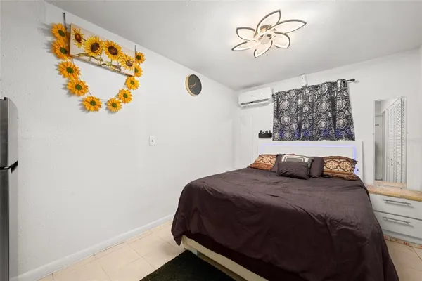 a bedroom with a bed and a painting on the wall