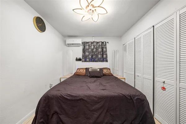 a bedroom with a bed and a chandelier