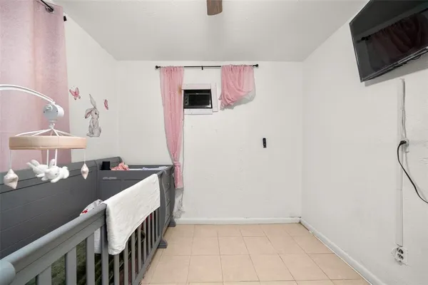 a hallway with a white cabinets a sink and wooden floor