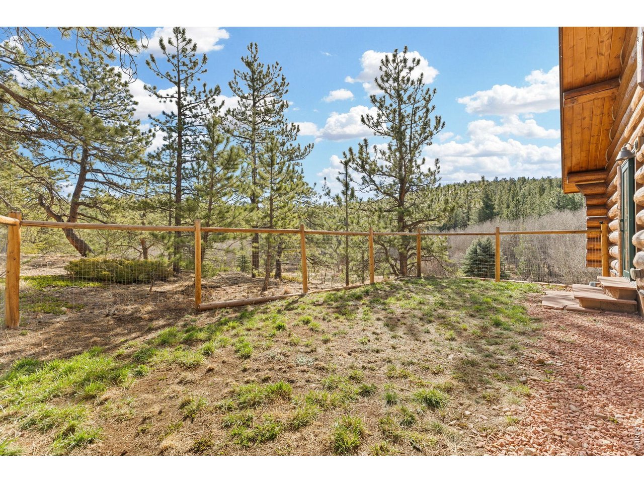 470 Big John Road Lyons, CO 80540 - Photo 23 of 44 Small fenced yard outside of the main floor primary suite