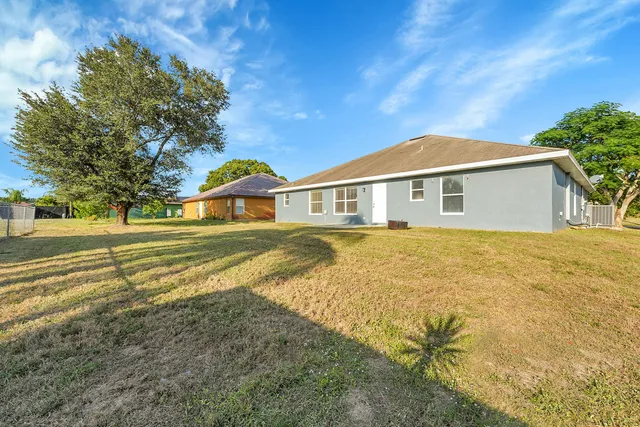 a view of a house with a yard patio and fire pit