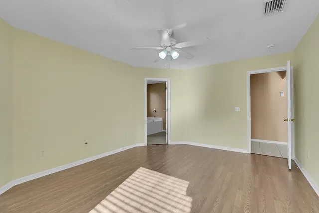 a bathroom with a granite countertop sink a mirror and a shower