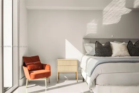 a bedroom with a bed and chair