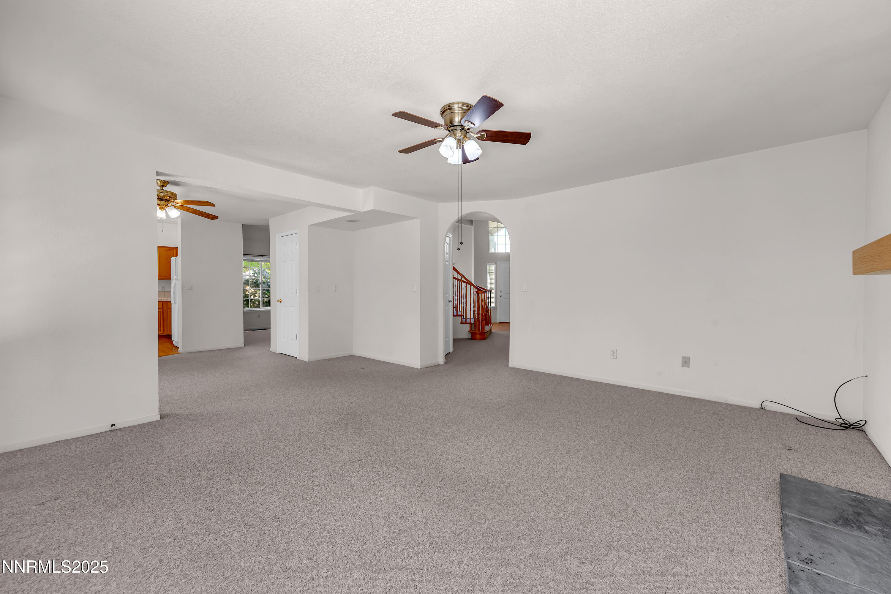 1850 Tess Way Reno, NV 89511 - Photo 17 of 50 a view of a livingroom with a ceiling fan and staircase