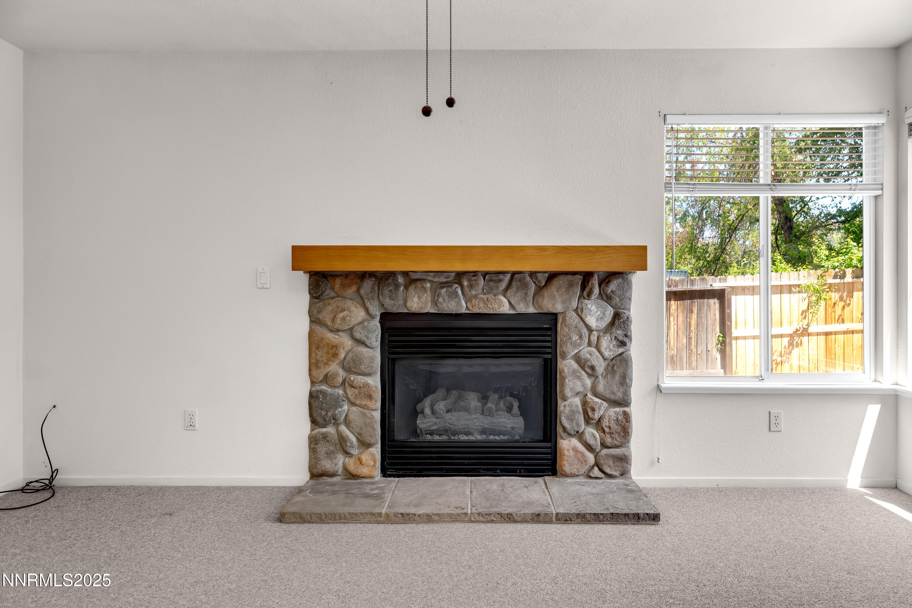 1850 Tess Way Reno, NV 89511 - Photo 19 of 50 a living room with a fireplace and a fireplace