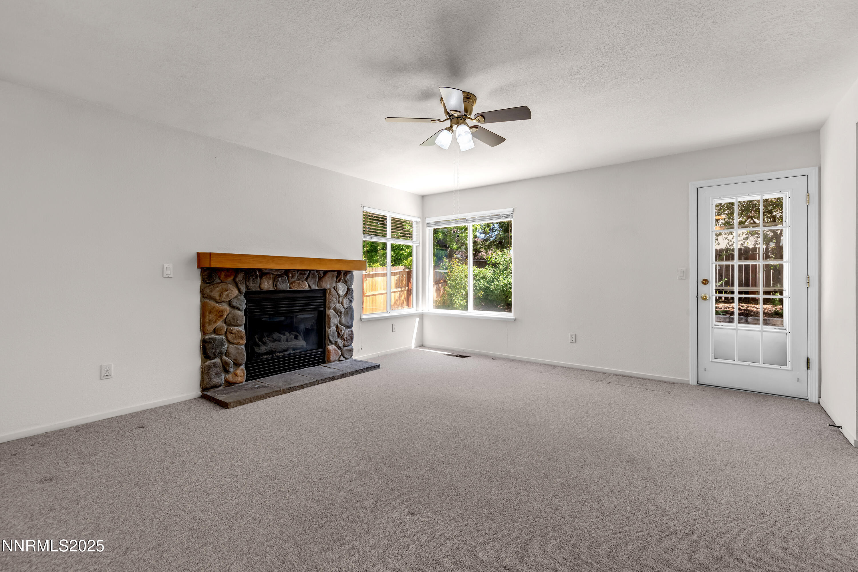 1850 Tess Way Reno, NV 89511 - Photo 20 of 50 a view of an empty room with a fireplace and a window