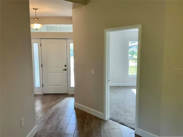 an empty room with wooden floor and a window