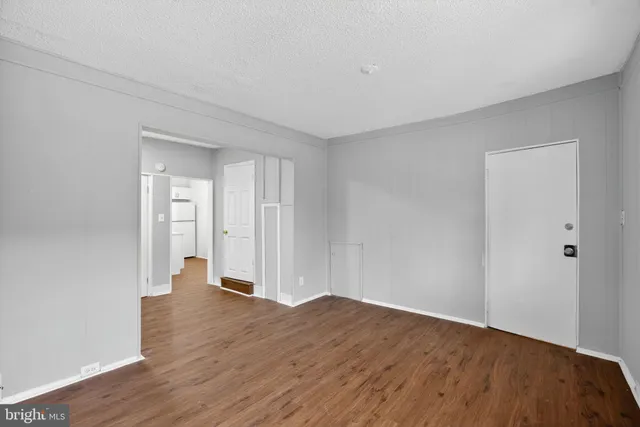 a view of wooden floor and windows in a room