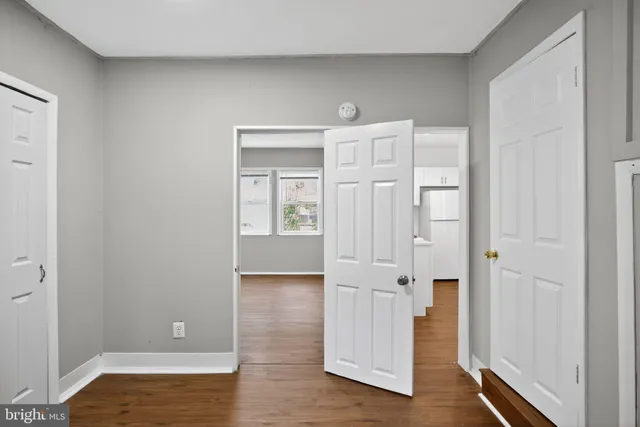a view of empty room with wooden floor