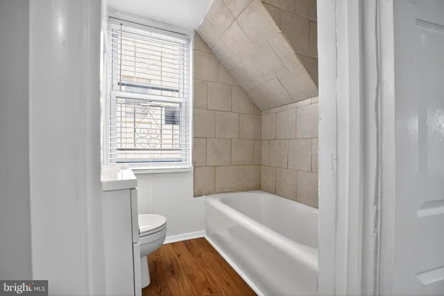a bathroom with a bathtub and a window
