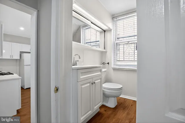 a bathroom with a toilet sink and a window