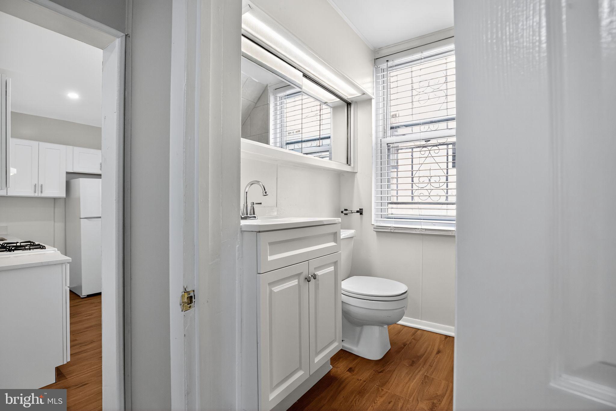 5446 Narcissus Avenue, Unit 1 Baltimore, MD 21215 - Photo 20 of 21 a bathroom with a toilet sink and a window