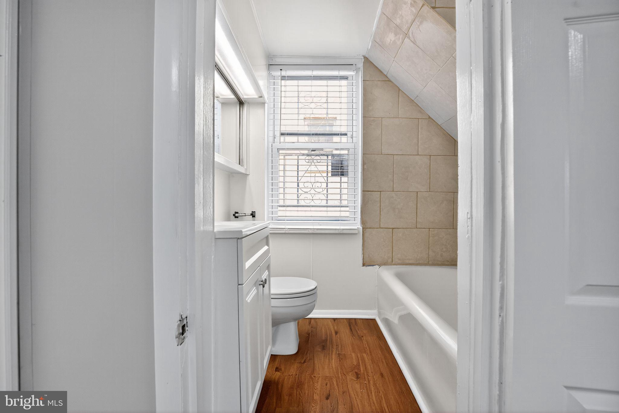 5446 Narcissus Avenue, Unit 1 Baltimore, MD 21215 - Photo 21 of 21 a bathroom with a tub shower and sink