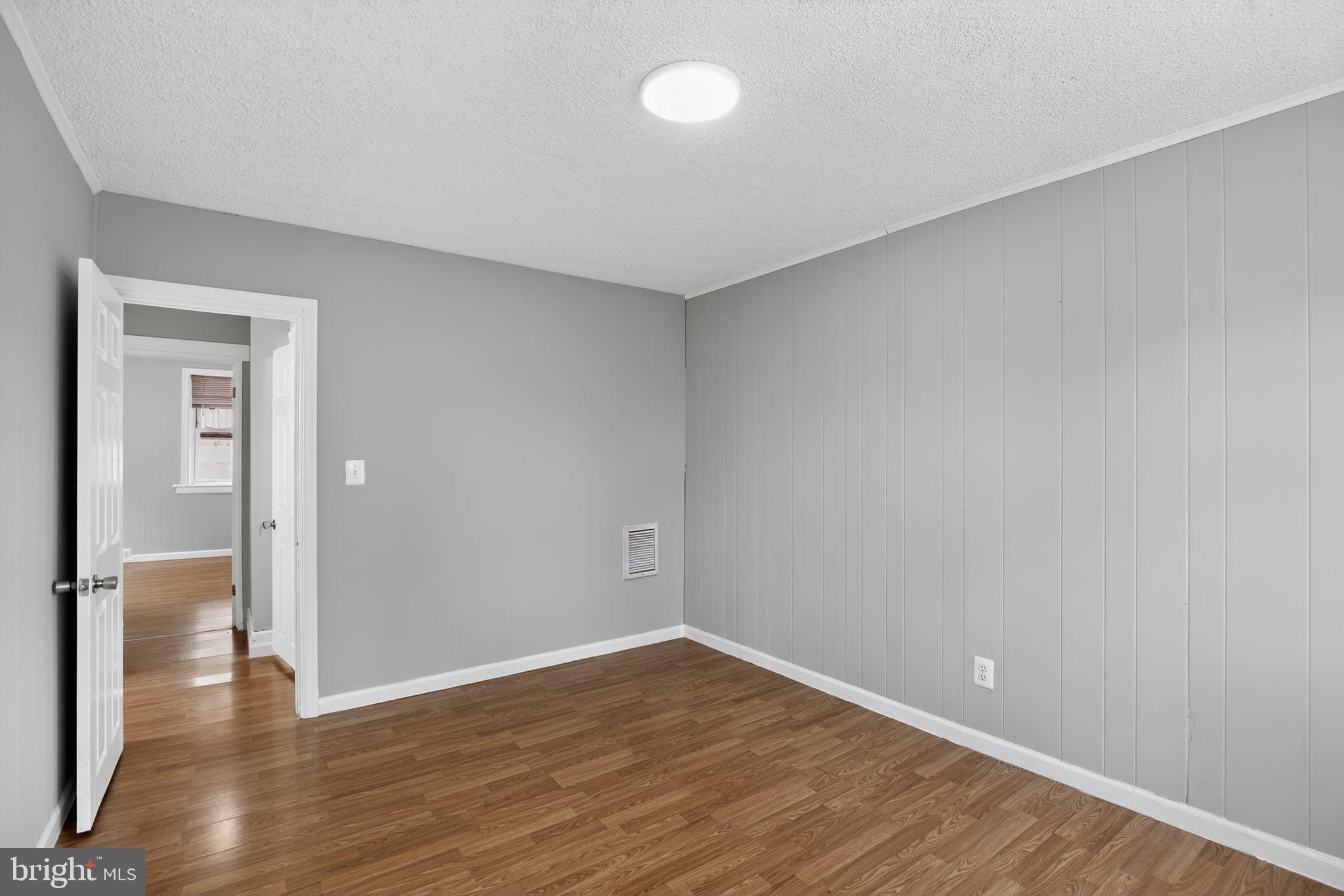 5446 Narcissus Avenue, Unit 1 Baltimore, MD 21215 - Photo 7 of 21 wooden floor in an empty room