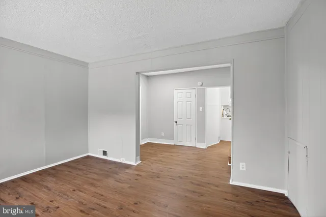 a view of an empty room and wooden floor